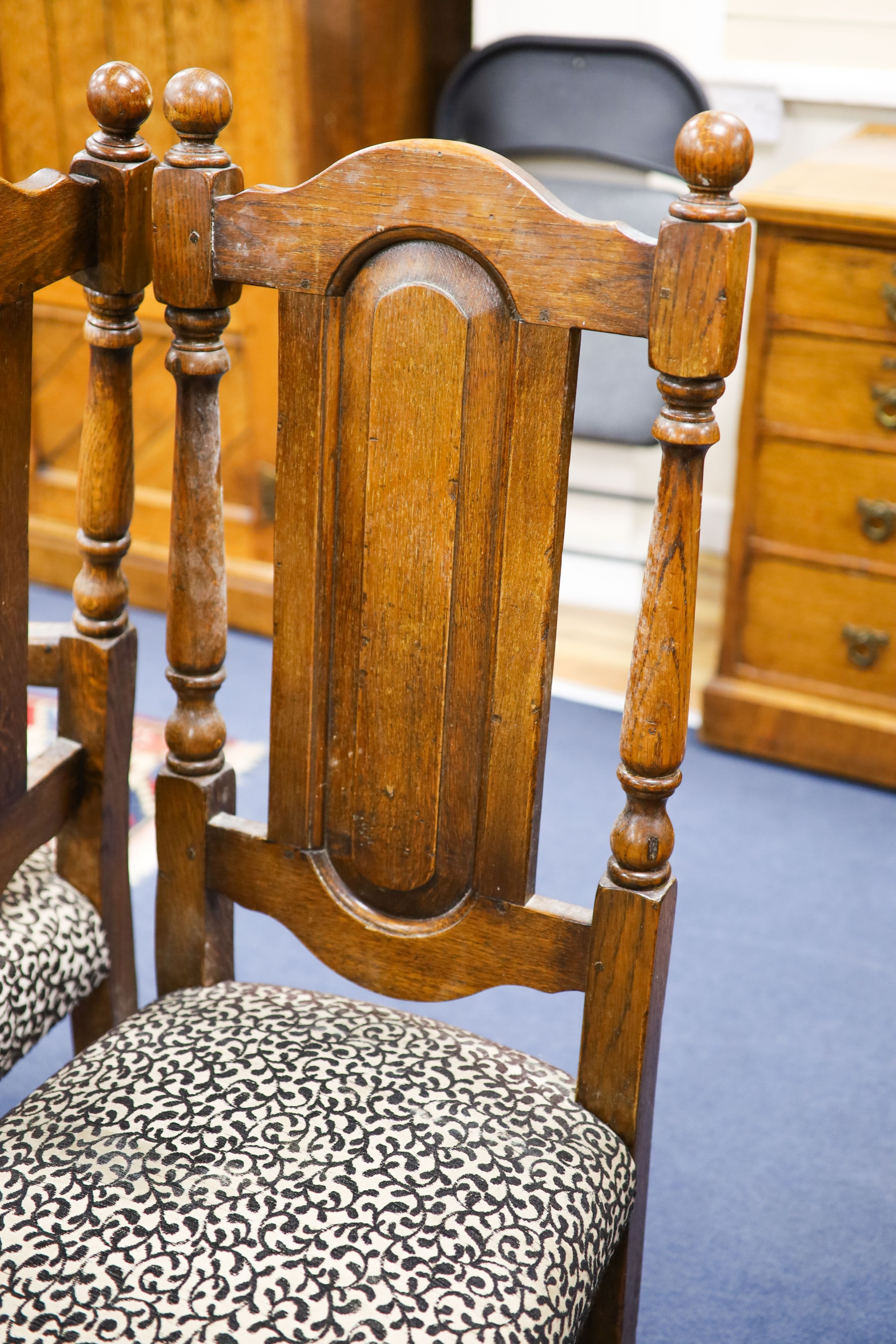 A set of ten 18th century style panelled oak dining chairs, two with arms